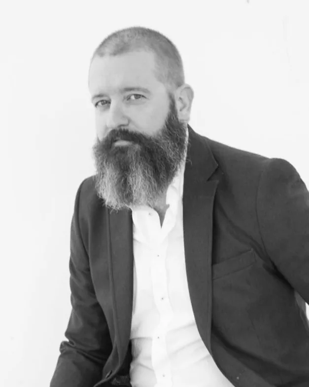 Black and white portrait of Mariano A. Hernández in a dark jacket and white shirt
